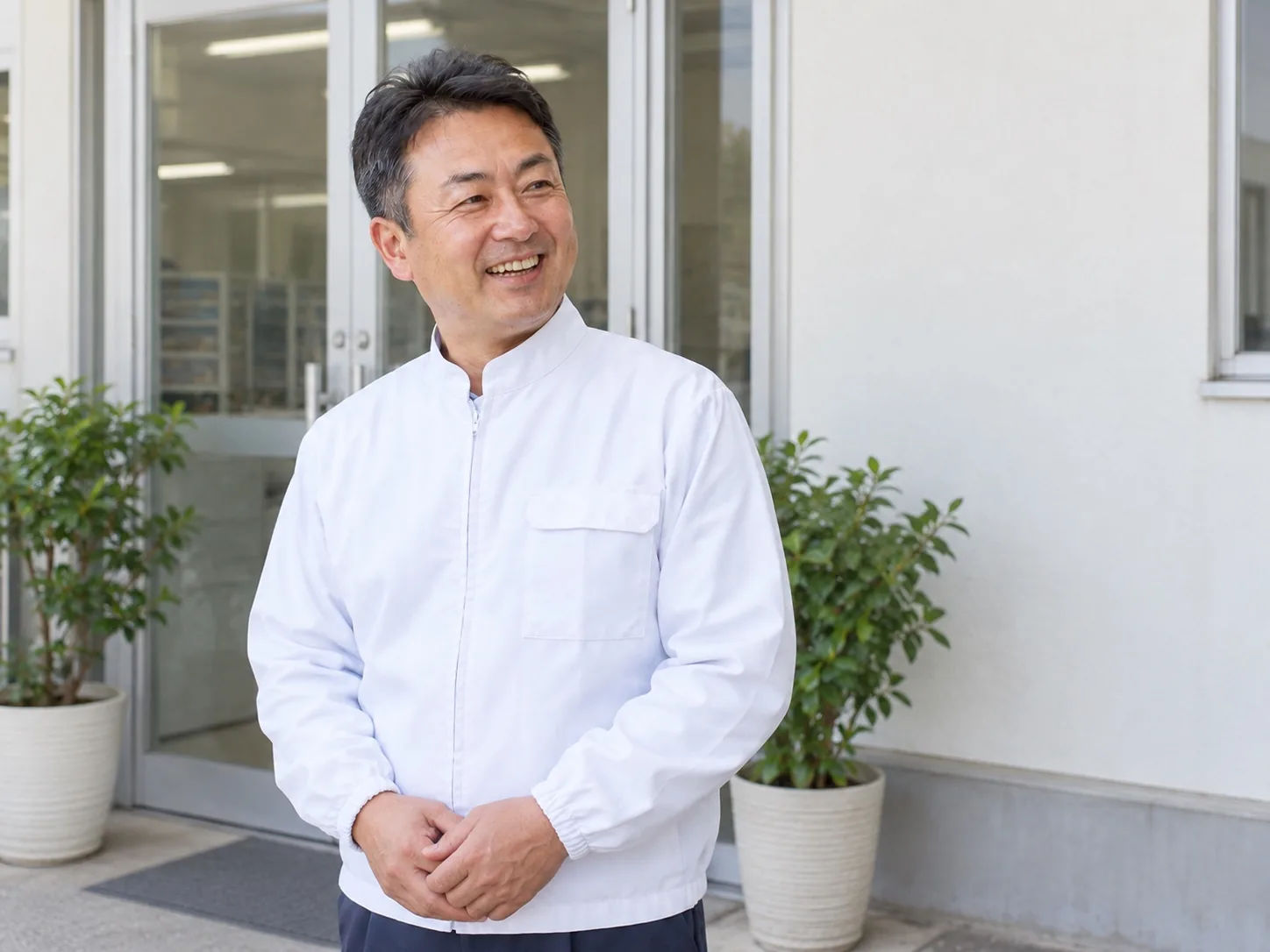 工場の入口に立つ代表